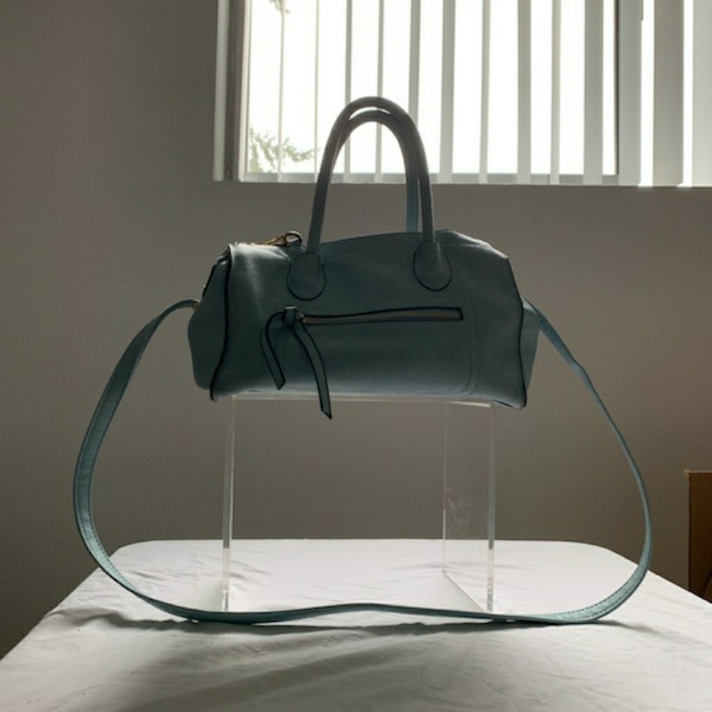 This is a light blue handbag by Guang Tong